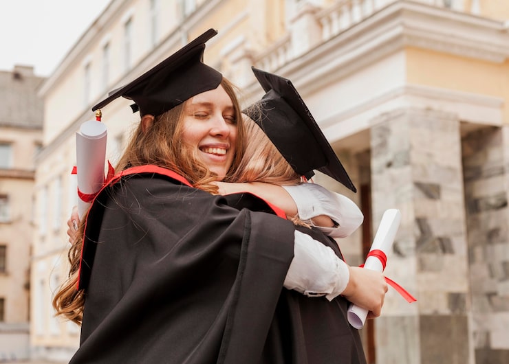 Postgraduate graduates celebrating at ceremony